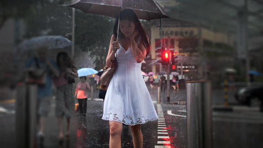 穿着白色连衣裙的女孩走进雨伞下