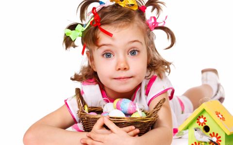 一篮复活节彩蛋在白色背景上的小女孩