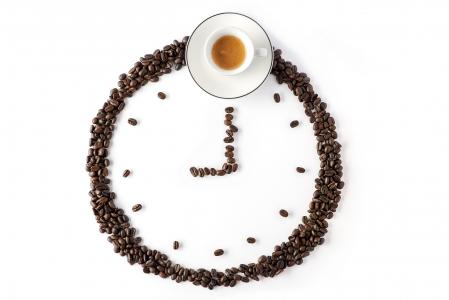 由咖啡豆和一杯咖啡在白色背景上的时钟