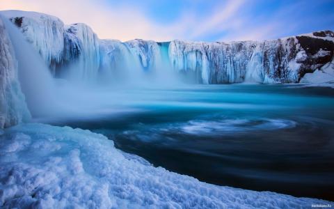 一个冰冻的瀑布和一个蓝色的泻湖