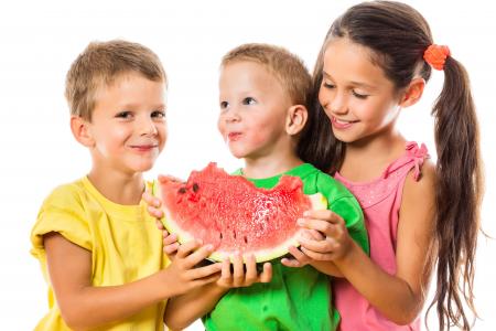 两个小男孩和一个女孩在白色背景上吃西瓜