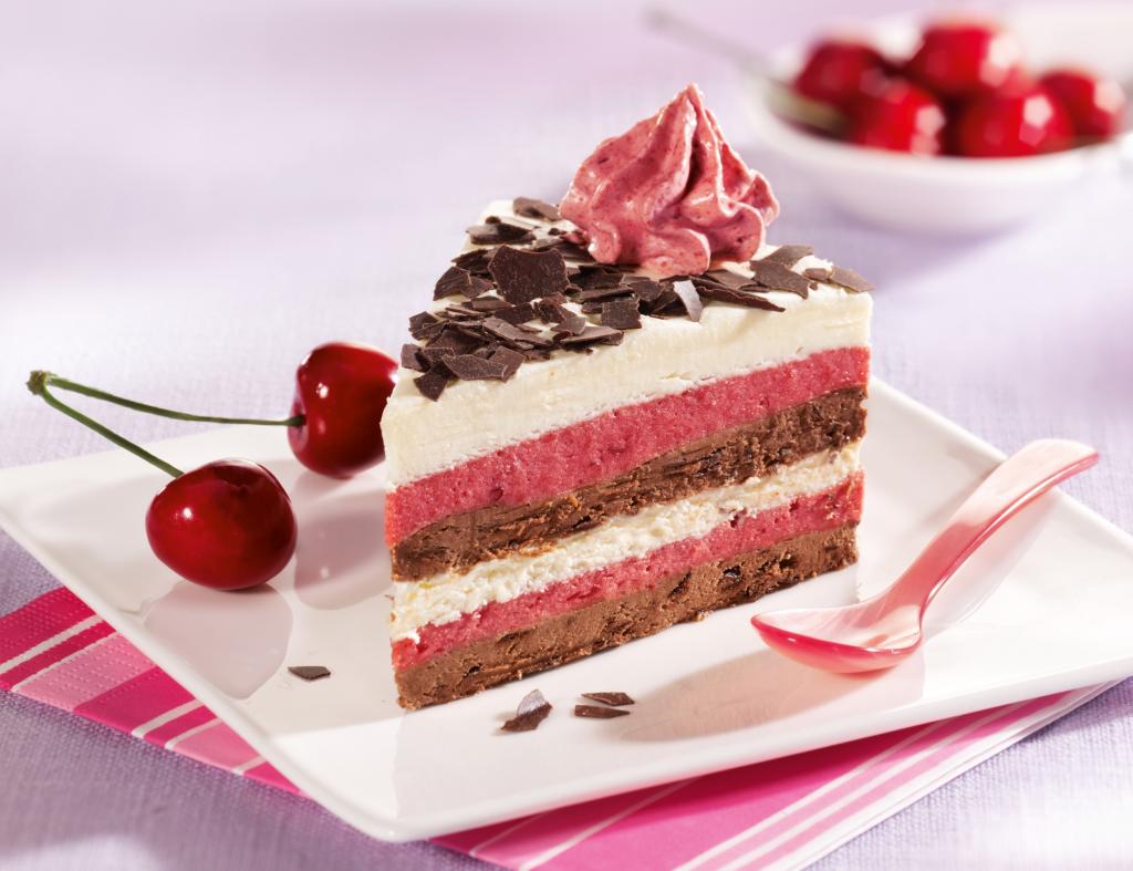 一块蛋糕与樱桃和巧克力奶油白板上